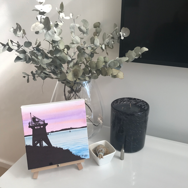 Newcastle harbour sunset with Nobby's breakwall navigation tower on easel in home setting