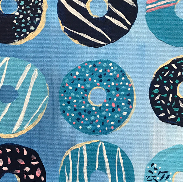 Closeup detail of blue decorated, iced donuts painting